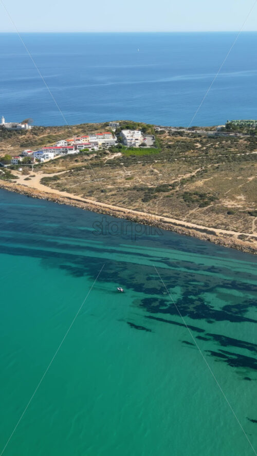 Aerial drone view of the coastline of Alicante, Spain in daylight. Vertical - Starpik Stock
