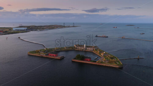 Aerial drone view of the historic Trekroner Fort with its lighthouse and old military buildings by the sea in Copenhagen, Denmark - Starpik Stock