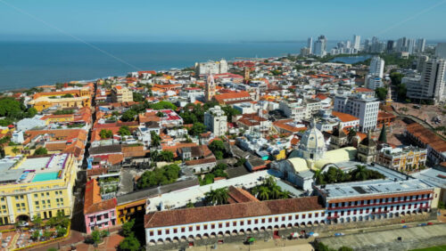 Aerial drone view of the historic center of Cartagena, Colombia alongside the Caribbean coast and promenade in daylight - Starpik Stock
