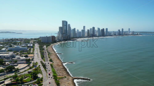 Aerial drone view of the historic center of Cartagena, Colombia alongside the Caribbean coast and promenade in daylight - Starpik Stock