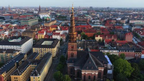 Aerial drone view of the iconic spiral tower of the Church of Our Saviour in Copenhagen, Denmark - Starpik Stock