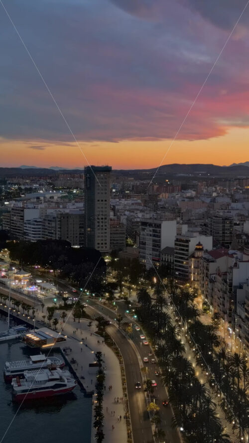 Aerial drone view of the sea and the Alicante city in Spain at sunset. Vertical - Starpik Stock