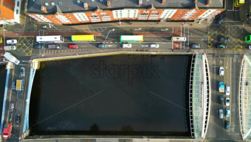 Aerial drone view of traffic flowing through Dublin, Ireland, over the River Liffey - Starpik Stock