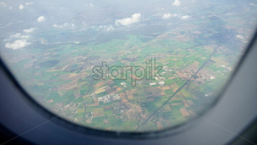 Aerial view of fields and towns from an airplane window - Starpik Stock