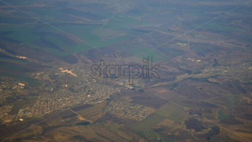 Aerial view of fields and towns from an airplane window - Starpik Stock