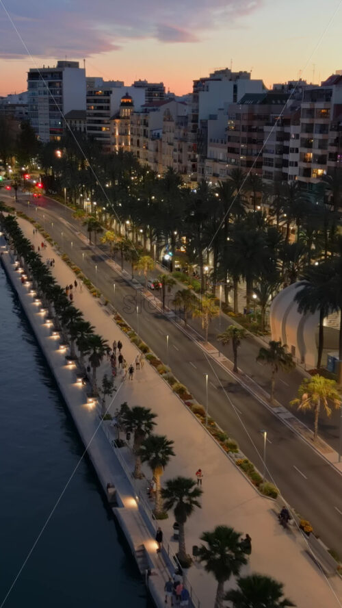 Alicante, Spain – June 20, 2025: Aerial drone view of the Santa Barbara Castle surrounded by buildings on the coast of the city with the sea on the background. Vertical - Starpik Stock