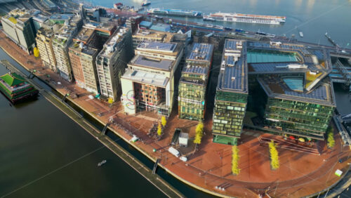 Amsterdam, Netherlands – November 19, 2024: Aerial drone view of the Conservatorium Hotel and surrounding waterfront area in the Oosterdokseiland area - Starpik Stock