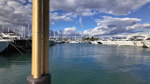 Antibes, France – July 13, 2025: Boats docked in the Port Vauban with the Fort Carre on the background - Starpik Stock