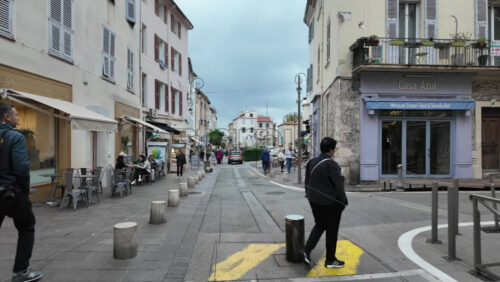 Antibes, France – July 14, 2025: People walking on the streets of the city on a cloudy day - Starpik Stock