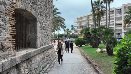 Antibes, France – July 14, 2025: People walking on the streets of the city on a cloudy day - Starpik Stock