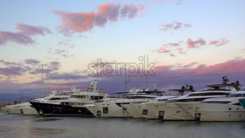 Antibes, France – July 2, 2025: Multiple white boats docked in the Port Vauban at sunset - Starpik Stock