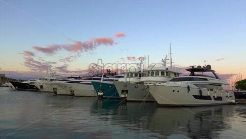 Antibes, France – July 2, 2025: Multiple white boats docked in the Port Vauban at sunset - Starpik Stock