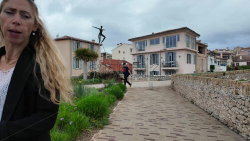 Antibes, France – July 20, 2025: People walking on the coast, near the bronze sculptures by Nicolas Lavarenne - Starpik Stock