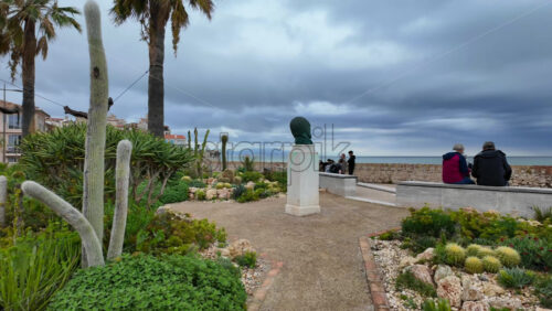 Antibes, France – July 20, 2025: People walking on the coast, near the bronze sculptures by Nicolas Lavarenne - Starpik Stock