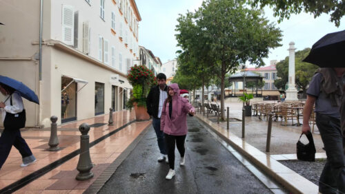 Antibes, France – July 20, 2025: People walking on the streets of the city in the rain - Starpik Stock