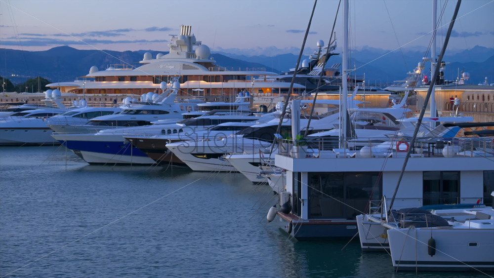 Antibes, France – June 7, 2025: Multiple white boats docked in the Port Vauban in the evening - Starpik Stock