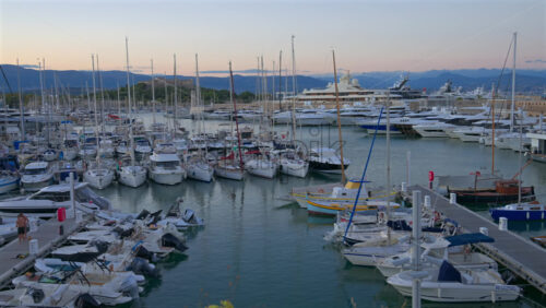 Antibes, France – June 7, 2025: Multiple white boats docked in the Port Vauban with the Fort Carre on the background in daylight - Starpik Stock