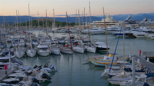 Antibes, France – June 7, 2025: Multiple white boats docked in the Port Vauban with the Fort Carre on the background in daylight - Starpik Stock