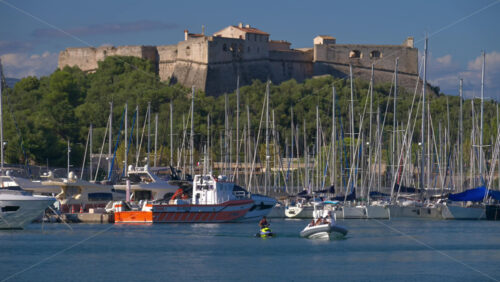 Antibes, France – June 7, 2025: Multiple white boats docked in the Port Vauban with the Fort Carre on the background in daylight - Starpik Stock