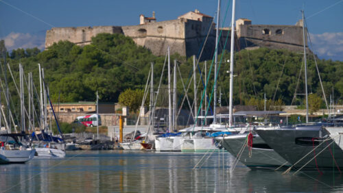 Antibes, France – June 7, 2025: Multiple white boats docked in the Port Vauban with the Fort Carre on the background in daylight - Starpik Stock