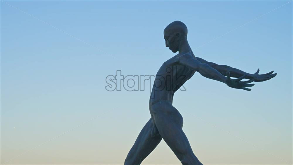 Antibes, France – June 8, 2025: Bronze sculpture “Grand Defi” by Nicolas Lavarenne with the sea in the background - Starpik Stock
