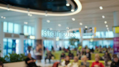 Blurred view of people waiting on chairs at the Chisinau International Airport in Moldova - Starpik Stock
