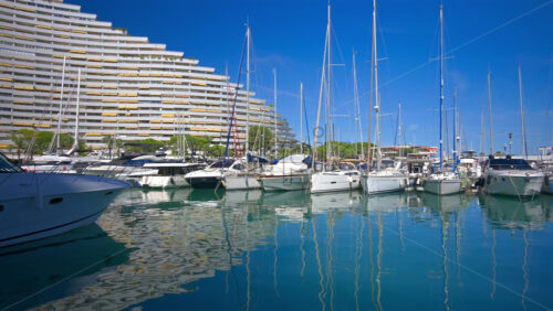 Boats docked in the Marina Baie des Anges in Villeneuve-Loubet, France in daylight - Starpik Stock