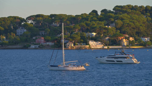 Boats floating on the Mediterranean Sea in daylight in Antibes, France - Starpik Stock