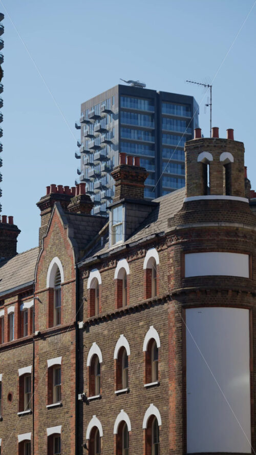 Buildings in central London, England with contrasting red and brown facades in daylight. Vertical - Starpik Stock