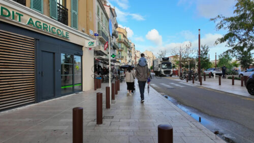 Cannes, France – August 4 2025: People walking near different stores and boutiques in daylight - Starpik Stock