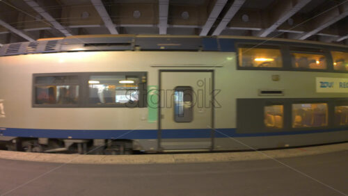 Cannes, France – July 10, 2025: Blue and white regional train pulls through a covered station platform - Starpik Stock