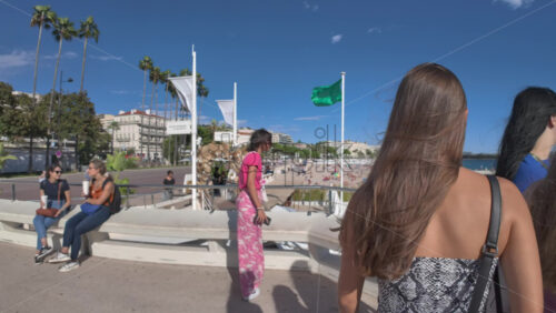 Cannes, France – July 10, 2025: People walking on the streets of the city, near the beach in daylight - Starpik Stock