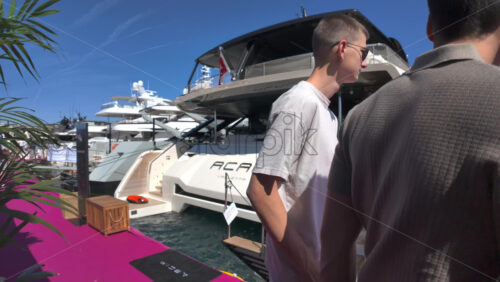 Cannes, France – July 10, 2025: View of boats docked in the Cannes marina near a red carpet - Starpik Stock