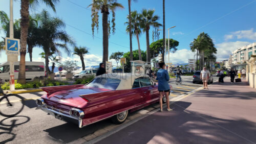 Cannes, France – July 12, 2025: People walking along the seafront on a sunny day - Starpik Stock