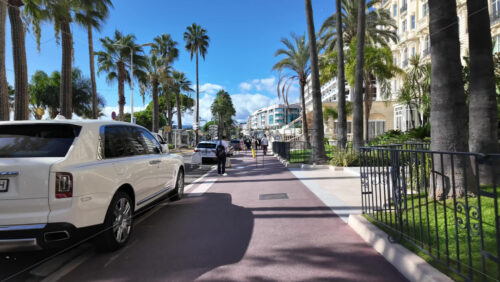 Cannes, France – July 12, 2025: People walking along the seafront on a sunny day - Starpik Stock