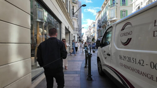 Cannes, France – July 12, 2025: People walking on the streets of the city on a sunny day - Starpik Stock