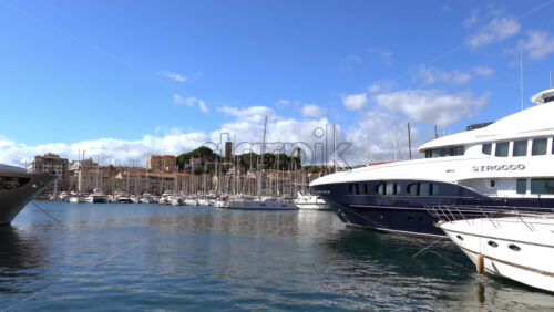 Cannes, France – July 2, 2025: Multiple white boats docked in the Old Port of Cannes in daylight - Starpik Stock