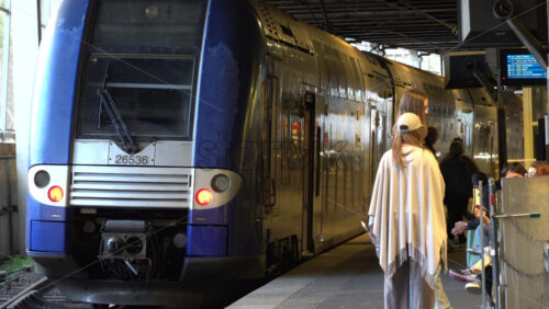 Cannes, France – July 2, 2025: Regional French train at a station platform as passengers board and prepare for departure - Starpik Stock
