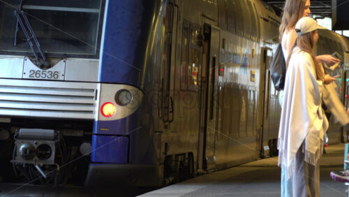 Cannes, France – July 2, 2025: Regional French train at a station platform as passengers board and prepare for departure - Starpik Stock
