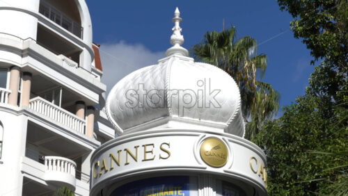 Cannes, France – July 2, 2025: White, rotating signboard with the words Cannes in gold - Starpik Stock