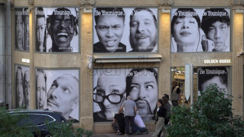 Cannes, France – July 6, 2025: Facade of the Golden Goose store in Cannes, covered with large black-and-white portraits promoting the Be Younique campaign - Starpik Stock