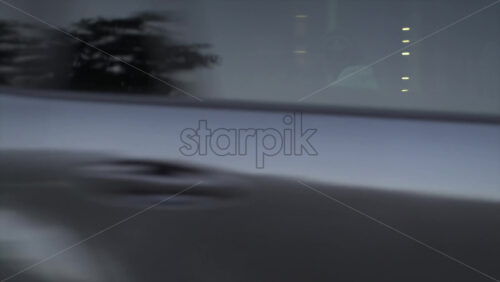 Cannes, France – July 6, 2025: Man in white clothing and helmet sitting on a Harley-Davidson motorcycle at a pedestrian crossing in the city centre - Starpik Stock