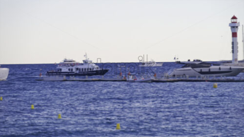 Cannes, France – June 22, 2025: Distant view of boats moving on the Mediterranean Sea in daylight - Starpik Stock