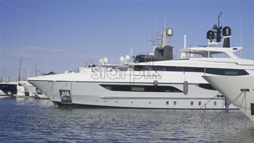 Cannes, France – June 22, 2025: Large white yachts docked in the Cannes harbour in daylight - Starpik Stock
