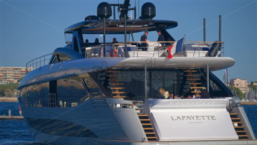 Cannes, France – June 22, 2025: People in a boat floating in the Cannes harbour in daylight - Starpik Stock