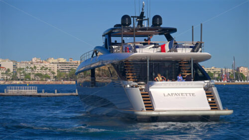 Cannes, France – June 22, 2025: People in a boat floating in the Cannes harbour in daylight - Starpik Stock