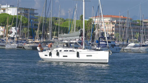 Cannes, France – June 22, 2025: People in a boat moving through the Cannes harbour in daylight - Starpik Stock