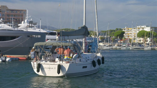 Cannes, France – June 22, 2025: People in a boat moving through the Cannes harbour in daylight - Starpik Stock