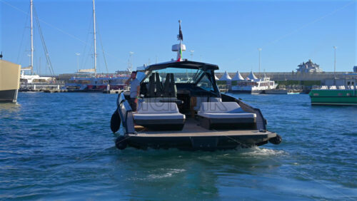 Cannes, France – June 22, 2025: People in a boat moving through the Cannes harbour in daylight - Starpik Stock