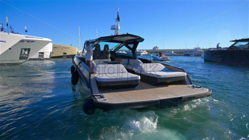 Cannes, France – June 22, 2025: People in a boat moving through the Cannes harbour in daylight - Starpik Stock